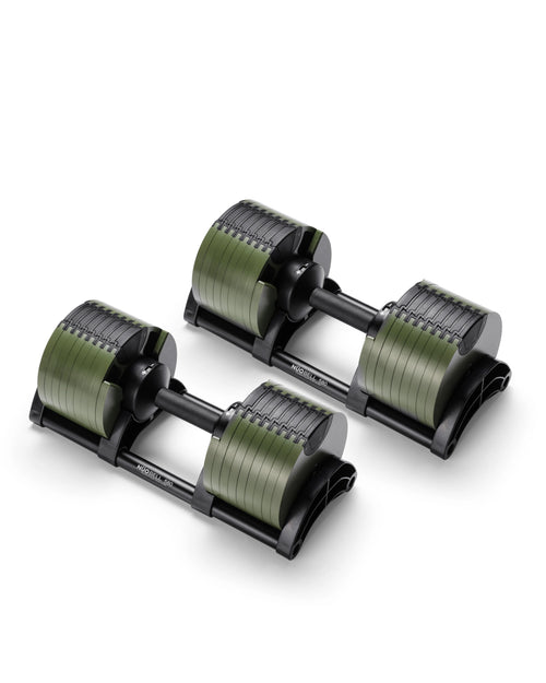 NÜOBELL 580 adjustable dumbbells in olive green finish, positioned on integrated cradle stands and highlighting the layered weight plate configuration and patented twist-handle adjustment system.