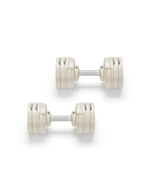 NÜOBELL S 560 Sand adjustable dumbbell in a stylish sand color, designed for home gyms, with advanced weight range and compact, space-saving construction.