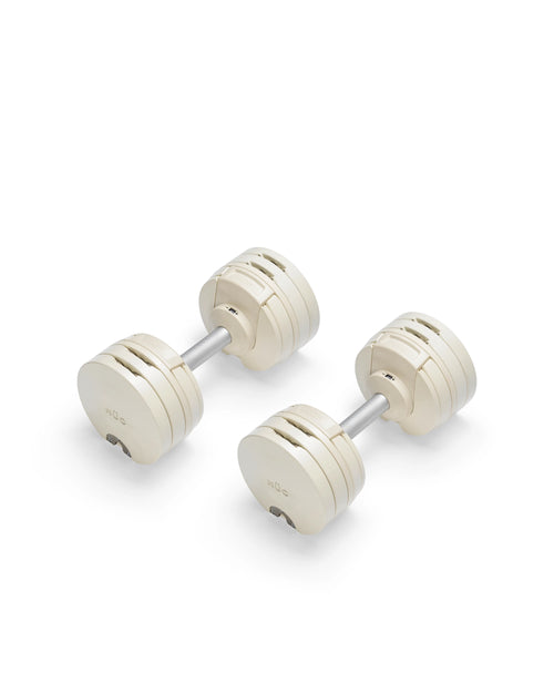 NÜOBELL S 560 Sand adjustable dumbbell in a stylish sand color, designed for home gyms, with advanced weight range and compact, space-saving construction.