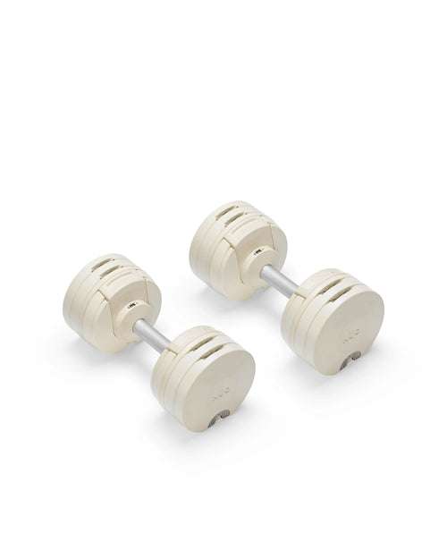 NÜOBELL S 560 Sand adjustable dumbbell in a stylish sand color, designed for home gyms, with advanced weight range and compact, space-saving construction.