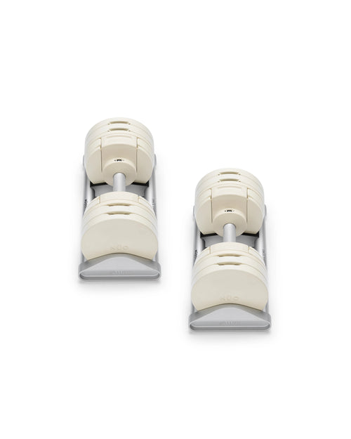 NÜOBELL S 560 Sand adjustable dumbbell in a stylish sand color, designed for home gyms, with advanced weight range and compact, space-saving construction.