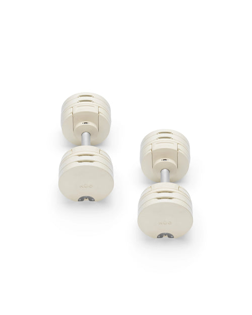 NÜOBELL S 560 Sand adjustable dumbbell in a stylish sand color, designed for home gyms, with advanced weight range and compact, space-saving construction.
